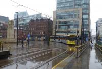 Metrolink 3031 swings round the corner from the new <I>Second City Crossing</I> line and into the greatly enlarged St Peters Square tram stop on a wet 27th March 2018. This was a Rochdale to East Disdbury service. <br><br>[Mark Bartlett 27/03/2018]