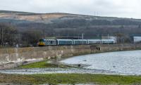 A trial run of the new sleeper coaches from Polmadie to Arrochar and Tarbet passes Craigendoran Junction. Unexpectedly this did not pause and was able to take a run at the climb to Helensburgh Upper with a friendly hoot as it passed. (I have wondered for years what the strange brackets are seen below the train, does anyone know?)<br><br>[Ewan Crawford 12/04/2018]