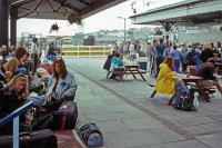 Homeward bound holidaymakers have time to pause and reflect at Newquay station in July 1992. They are waiting to board the HST service to Paddington and, in a wider sense, also waiting to fill interludes such as this with mobile phones and the internet.<br><br>[Mark Dufton /07/1992]