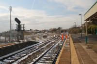 A pair of Network Rail Technicians working on a set of frozen points at the south end of Barry station. The Barry Island branch curves left with the Vale of Glamorgan lines straight ahead.<br><br>[Alastair McLellan 19/03/2018]