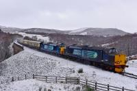 After some heavy overnight snow, the Pathfinder <I>Easter Chieftain</I> is<br>
pictured going south over Slochd Viaduct on the way back to Cardiff from<br>
Inverness, hauled by DRS liveried 37605 and 37259. 2nd April 2018.<br>
<br>
<br><br>[John Gray 02/04/2018]