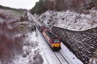 Still in full EWS livery, 67007 hauls the late running Caledonian Sleeper through the winterscape near Slochd Summit on 2nd April 2018.<br>
<br>
<br><br>[John Gray 02/04/2018]