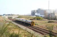 The Sunday 0911 Edinburgh Waverley -Tweedbank, consisting of a 5-car 158+170 combination, running south midway between Newcraighall and Shawfair stations on a sunny 15 April 2018. In the background are the recycling plants which now occupy much of the west side of the former Millerhill Marshalling Yard. On the left is the Biogen food waste processing facility, while on the right is the under construction Edinburgh and Midlothian Recycling and Energy Recovery Centre (which has recently gained a tall chimney).  <br><br>[John Furnevel 15/04/2018]