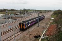 Services to Blackpool North resumed again on 16th April 2018, although initially these were limited to an hourly Manchester Airport service while driver training and some bustitution continued. 156455, travelling over the revised track layout under the newly installed catenary, passes the site of the demolished signal box at Kirkham North Junction. [See image 63638] for the same location in 2001.<br><br>[Mark Bartlett 16/04/2018]