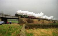 4472 'Flying Scotsman' working The Cumbrian Mountain Express on 30 March 1991, climbing from Settle Jct, over the A65 road towards Settle station. The tour had started at Kings Cross but 4472 only came on at Blackburn to work the final leg of the outward journey to Carlisle. The return trip that day was hauled by 60009 then running as 'Osprey'.<br><br>[John McIntyre 30/03/1991]