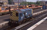 Stirling pilot 08630 parked in the station in May 1990, with a busy freight scene in the background.  <br><br>[Bill Roberton 13/05/1990]