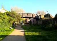 <h4><a href='/locations/B/Blandford_Forum'>Blandford Forum</a></h4><p><small><a href='/companies/D/Dorset_Central_Railway'>Dorset Central Railway</a></small></p><p>Looking South towards Bournemouth, the station footbridge has an air of permanence; not least because first floor flats on the right are accessed by ramps off the bridge approach. There is no sign, however, of the former subway; while the buffer stop under the bridge is not in its original position. 68/85</p><p>05/05/2018<br><small><a href='/contributors/Ken_Strachan'>Ken Strachan</a></small></p>