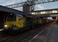 Still ugly after dark - Freightliner 70006 pauses in Nuneaton for a driver change with a southbound Freightliner, about to turn right for Coventry on 19th October 2018.<br><br>[Ken Strachan 19/10/2018]