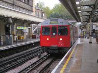 <h4><a href='/locations/H/High_Street_Kensington'>High Street Kensington</a></h4><p><small><a href='/companies/M/Metropolitan_Railway'>Metropolitan Railway</a></small></p><p>LU C stock (now withdrawn) with a District Line service from Wimbledon to Edgware Road arriving at High Street Kensington station on 9th November 2013.  This station was originally opened by the Metropolitan Railway with the line from Praed Street junction, Paddington to South Kensington on 1st October 1868 but has for very many years now been served by District and Circle Line trains. 11/14</p><p>09/11/2013<br><small><a href='/contributors/David_Bosher'>David Bosher</a></small></p>