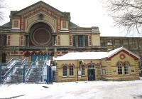 <h4><a href='/locations/A/Alexandra_Palace_1st'>Alexandra Palace [1st]</a></h4><p><small><a href='/companies/M/Muswell_Hill_Railway'>Muswell Hill Railway</a></small></p><p>The former entrance building to the first-named Alexandra Palace station, terminus of the GNR branch from Highgate and Finsbury Park, dwarfed by the huge bulk of the palace itself on the left and above, in snowy conditions on 20th December 2010. The steps to the left were designed wide to enable crowds of visitors to be swept off the trains and into the palace as quickly as possible but haven't been used, I think, since the line closed. The pre-war scheme to convert the line into a branch of the Northern Line was begun but, despite being nearly completed at the outbreak of WWII, was left in abeyance and then not proceeded with after 1945 and the line, once promised a bright new future, closed instead in 1954. With so much work completed at a cost of more than Â£1 million, this is a shameful blot on London Transport's otherwise rich history. The station entrance building (all that survives, the island platform in the cutting below the palace walls having been demolished) was derelict and boarded up for very many years but has now been renovated and is in use as a community centre and given the name CUFOS: Community Use For Old Station. 10/51</p><p>20/10/2010<br><small><a href='/contributors/David_Bosher'>David Bosher</a></small></p>