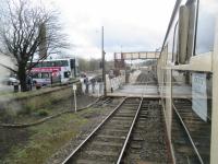 <h4><a href='/locations/R/Ramsbottom'>Ramsbottom</a></h4><p><small><a href='/companies/E/East_Lancashire_Railway'>East Lancashire Railway</a></small></p><p>East Lancashire Railway train from Bury Bolton Street to Rawtenstall departing from Ramsbottom over the level crossing. This view looks back south towards the station with a local bus on the left, waiting for the crossing gates to reopen, on 5th April 2016. 8/17</p><p>05/04/2016<br><small><a href='/contributors/David_Bosher'>David Bosher</a></small></p>