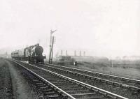 Class 2P 4-4-0 no 40645 passing the site of Barrhead North Junction on 10 April 1953 with a Kilmarnock - St Enoch train. Part of the large Shanks & Co works stands in the background.