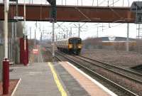 A northbound train from Lanark heading for Glasgow about to call at Shieldmuir station on 22 March 2006. The huge Shieldmuir Royal Mail depot now occupies the area in the right background.<br><br>[John Furnevel 22/03/2006]