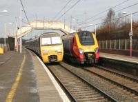 An up Voyager passes the morning North Berwick - Glasgow Central via Carstairs service leaving Carluke in March 2006.<br><br>[John Furnevel 10/03/2006]