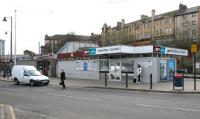 Looking south east from the bus station towards Hamilton Central on 17 March 2006. Behind and above the station is Kemp Street, where the former Caledonian booking office and south side entrance (which accessed the platforms via a covered stairway) still survives [see image 9044]. <br><br>[John Furnevel 17/03/2006]