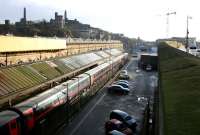 View east over the Waverley <I>sub</I> platforms early on Sunday 26 March 2006, with the the car parking area running alongside and Market Street upper right. The old platform canopy looks as though it has seen better days. The train boarding at platform 21 is a GNER service for Kings Cross. [See image 58751]<br><br>[John Furnevel 26/03/2006]