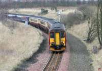 Second of the Hibs football specials destined for Kings Park approaching Niddrie West on the curve round from Brunstane on 2 April 2006. Given that Hibs Hampden opponents on this occasion were Hearts perhaps a little more thought could have been given to the livery of the train used on this particular service.<br><br>[John Furnevel 02/04/2006]