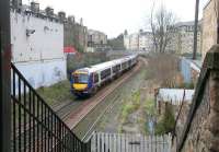 The former station steps and remains of the eastbound platform at Morningside Road station with a diverted Waverley - Queen Street service passing on Sunday 2 April 2006.<br><br>[John Furnevel 02/04/2006]
