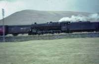 Fireman of 45026 holds his hat on as it speeds through Elvanfoot.<br><br>[John Robin 25/03/1966]