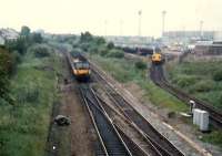 477 E&G train heads for Glasgow past a 37 oil train leaving the Bishopbriggs oil terminal.<br><br>[Ewan Crawford //1987]