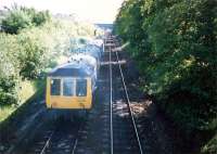 DMU 107438 smokily heads for the site of Strathbungo station.<br><br>[Ewan Crawford //1987]