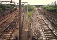 Looking south towards Barnhill station. From left to right; CGU from Bellgrove, Chord to Germiston, Sighthill Branch to yard and (lifted and overgrown) original approach to Sighthill Yard.<br><br>[Ewan Crawford //1987]