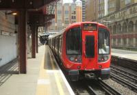 <h4><a href='/locations/B/Barbican'>Barbican</a></h4><p><small><a href='/companies/S/South_Kensington_Extension,_Minories_Extension_Metropolitan_Railway'>South Kensington Extension, Minories Extension (Metropolitan Railway)</a></small></p><p>LUL S8 stock on a short Hammersmith & City Line working to Moorgate departing from its penultimate stop at Barbican on a hot and sultry 13th July 2013. This station opened as Aldersgate Street in 1865 with the first extension of the world's first Underground, the Metropolitan Railway, from Farringdon Street (now Farringdon) to Moorgate Street (now Moorgate). It was renamed Aldersgate & Barbican in 1923 (although it was only ever shown on the LU diagram as Aldersgate) before being renamed simply Barbican in 1968. It once boasted a fine all-weather protection glass roof which was destroyed during the London 'Blitz' of World War Two. The frame was taken down in 1955 but it is still possible to see the support brackets above the arches on the walls. On the right are the disused Widened Lines platforms. For many years, this station was closed on Sundays but is now open full time again. 11/21</p><p>26/08/2013<br><small><a href='/contributors/David_Bosher'>David Bosher</a></small></p>