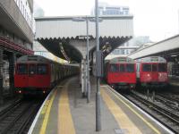 <h4><a href='/locations/E/Edgware_Road'>Edgware Road</a></h4><p><small><a href='/companies/M/Metropolitan_Railway'>Metropolitan Railway</a></small></p><p>Three grubby LUL C stock trains (now withdrawn) at Edgware Road on 10th January 2013, the 150th anniversary of the opening of the Metropolitan Railway although the present station here is a rebuild dating from 1925. On the outsides are two Circle Line trains and in the middle a District Line train to Wimbledon. 4/14</p><p>10/01/2013<br><small><a href='/contributors/David_Bosher'>David Bosher</a></small></p>