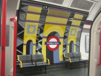 <h4><a href='/locations/M/Marble_Arch'>Marble Arch</a></h4><p><small><a href='/companies/C/Central_London_Railway'>Central London Railway</a></small></p><p>Gaudy murals at Marble Arch, seen from eastbound train of LUL 1992 stock waiting to depart with a Central Line service to Epping, on 18th January 2014. This station, situated in the heart of London's West End, was opened on 30th July 1900 with the first stage of the Central London Railway from Shepherd's Bush to Bank.  Now part of the much extended Central Line to which it was renamed by the LPTB in 1937. 20/138</p><p>18/01/2014<br><small><a href='/contributors/David_Bosher'>David Bosher</a></small></p>