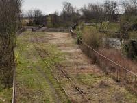 <h4><a href='/locations/L/Levenmouth'>Levenmouth</a></h4><p><small><a href='/companies/L/Leven_Dock_Railway'>Leven Dock Railway</a></small></p><p>Looking east from the Bawbee Brig towards the former Methil East Junction and the site of the demolished Methil Power Station showing the surviving redundant track. To the right is the course of the Docks branch. The east end of the platforms of Levenmouth station will be in the foreground. The Bawbee Bridge will straddle the platforms. 15/43</p><p>10/04/2021<br><small><a href='/contributors/Bill_Roberton'>Bill Roberton</a></small></p>