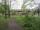 <h4><a href='/locations/P/Palace_Gates_Wood_Green'>Palace Gates Wood Green</a></h4><p><small><a href='/companies/P/Palace_Gates_Branch_Great_Eastern_Railway'>Palace Gates Branch (Great Eastern Railway)</a></small></p><p>View along the trackbed of the former Palace Gates branch. with a makeshift footpath cutting diagonally across (the line went off to the left), towards the site of Palace Gates Wood Green station, marked by the houses, on 8th May 2021. This closed to passengers on 7th January 1963 and to freight on 5th October 1964.  When the line was in use, a pedestrian subway was available to cross the line but that has long been filled in and replaced by a level walkway in front of where the station used to be. 40/51</p><p>08/05/2021<br><small><a href='/contributors/David_Bosher'>David Bosher</a></small></p>