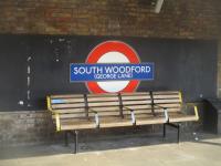 <h4><a href='/locations/S/South_Woodford'>South Woodford</a></h4><p><small><a href='/companies/L/Loughton_Branch_Eastern_Counties_Railway'>Loughton Branch (Eastern Counties Railway)</a></small></p><p>LU roundel at South Woodford, east London, seen from a Central Line service from Epping to West Ruislip on the evening of Sunday, 5th September 2021. This station was opened as George Lane by the Eastern Counties Railway in 1856 and renamed South Woodford (George Lane) by the LNER in 1937. It was first served by Underground trains when electrification was extended from Leytonstone to Woodford on 14th December 1947. According to Alan A. Jackson and Desmond F. Croome in their excellent tome 'Rails Through the Clay', the station lost the George Lane suffix in 1948 but some roundels, like this one, are still bearing the legend over seventy years later.  (When I still lived with my parents and first started work after leaving school, I went through this station every day on my daily commute between Loughton, where we lived, and Holborn.) 85/138</p><p>05/09/2021<br><small><a href='/contributors/David_Bosher'>David Bosher</a></small></p>