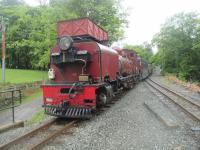 <h4><a href='/locations/B/Beddgelert'>Beddgelert</a></h4><p><small><a href='/companies/W/Welsh_Highland_Light_Railway'>Welsh Highland Light Railway</a></small></p><p>Ex-South African Railways NSGG Class 16 2-6-2+2-6-2 No.138 passing the water tank as it arrives at Beddgelert station with a Welsh Highland Railway train from Caernarfon to Porthmadog Harbour on 22nd May 2016. 138 was built by Beyer Peacock in 1958 and returned to the UK after withdrawal from service for restoration at the Ffestiniog Railway's Boston Lodge works. Originally in green livery, it was temporarily withdrawn in 2007 for full overhaul and boiler inspection and returned to service in its new crimson livery in 2010.   (In common with the Ffestiniog Railway, WHR trains cross on the right at stations with passing loops.) 19/75</p><p>22/05/2016<br><small><a href='/contributors/David_Bosher'>David Bosher</a></small></p>