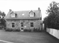 <h4><a href='/locations/B/Balerno'>Balerno</a></h4><p><small><a href='/companies/B/Balerno_Branch_Caledonian_Railway'>Balerno Branch (Caledonian Railway)</a></small></p><p>The former stationmaster and porters house of Balerno station still stands, in private ownership, as a reminder of the former station. This is a 1985 view of the building from Lanark Road West. The station was in the cutting to the right, since infilled and redeveloped. 7/81</p><p>//1985<br><small><a href='/contributors/Don_Shaw'>Don Shaw</a></small></p>