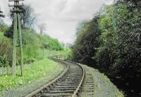<h4><a href='/locations/B/Balerno_Goods_Junction'>Balerno Goods Junction</a></h4><p><small><a href='/companies/B/Balerno_Branch_Caledonian_Railway'>Balerno Branch (Caledonian Railway)</a></small></p><p>A view showing the tight reverse curves just east of Balerno Goods Junction on the approach to waulk mill. The line was noteable for its tight curves as it followed the Water of Leith downhill to Slateford. 12/81</p><p>//<br><small><a href='/contributors/Don_Shaw'>Don Shaw</a></small></p>