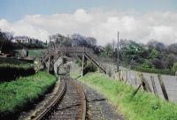 <h4><a href='/locations/I/Inglis_Mill'>Inglis Mill</a></h4><p><small><a href='/companies/B/Balerno_Branch_Caledonian_Railway'>Balerno Branch (Caledonian Railway)</a></small></p><p>The railway and a wooden footbridge seen looking east just east of Inglis Mill. The stone bridge beyond carried the access road for the mill. 52/81</p><p>//<br><small><a href='/contributors/Don_Shaw'>Don Shaw</a></small></p>