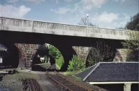 <h4><a href='/locations/C/Colinton'>Colinton</a></h4><p><small><a href='/companies/B/Balerno_Branch_Caledonian_Railway'>Balerno Branch (Caledonian Railway)</a></small></p><p>Colinton road bridge dominates the view in this photograph looking east towards the passenger station (note the cut back platform) with the goods yard off to the left. The building at a lower level on the right still stands and is located in Spylaw Park. 54/81</p><p>//<br><small><a href='/contributors/Don_Shaw'>Don Shaw</a></small></p>