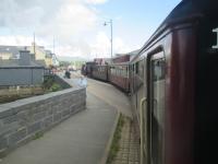 <h4><a href='/locations/P/Porthmadog_Harbour_WHR'>Porthmadog Harbour [WHR]</a></h4><p><small><a href='/companies/F/Festiniog_to_Welsh_Highland_Link'>Festiniog to Welsh Highland Link</a></small></p><p>Welsh Highland Railway train returning from Caernarfon now approaching the southern terminus at Porthmadog Harbour, negotiating the tramway-like level crossing before arriving at the station, on 22nd May 2016. Rebuilding of the entire length of this spectacular narrow gauge line, that had lain derelict since 1937, is one of the greatest and most remarkable achievements in the history of UK heritage railways. 2/10</p><p>22/05/2016<br><small><a href='/contributors/David_Bosher'>David Bosher</a></small></p>