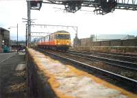 Coming south from Bridge Street Junction in 1987 is a Cathcart Circle train, while in the background another train is turning west on the Paisley line. On the extreme left of the picture is part of the Glasgow Central power signal box on Salkeld Street.<br><br>[Ewan Crawford //1987]