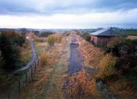 The closed Crosshouse station looking north-west. Route to left for Irvine and Ardrossan route straight ahead for Dalry and Glasgow. Not long after line lifted.<br><br>[Ewan Crawford //1987]