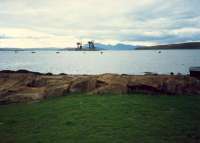 The pier that eclipsed all the others ... for bulk mineral importing. Fairlie Pier looking to Hunterston Pier. Mountains of Arran beyond.<br><br>[Ewan Crawford //1987]