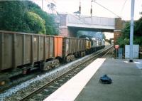 A loaded iron ore train from Hunterston to Ravenscraig passes West Kilbride in 1987.<br><br>[Ewan Crawford //1987]