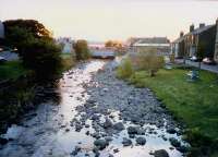 The sun sets over the Great Cumbrae, west of Largs. The river flows under Largs station.<br><br>[Ewan Crawford //1987]