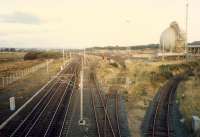 Ardeer looking east. From left to right; the Lanarkshire and Ayrshire Railway approached from the left (behind the camera),  Ardrossan line, sidings, Ardeer ICI Nylon, Ardeer Misk. The L&AR previously crossed over some distance behind the camera and swung to the right of this shot, but, after LMS modifications, merged here at Stevenston No 1. The structure is the Ammonia Sphere.<br><br>[Ewan Crawford //1987]