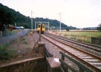 Having passed Dumbuck an eastbound service heads for the former Dunglass Junction.<br><br>[Ewan Crawford //1987]
