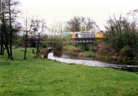 A 26 draws a long train west over the Devon Viaduct at Cambus. Due to the condition of the line the speed was very low.//8397,16450<br><br>[Ewan Crawford //1988]