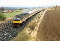 West and south of Midcalder Junction is an Edinburgh train heading for Carstairs and Carlisle.<br><br>[Ewan Crawford //1988]