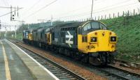 The mind boggles. Three coupled together 37s run past to enter the sidings by Carstairs station.<br><br>[Ewan Crawford //1988]