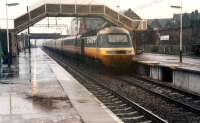 In a very heavy downpour a 125 diverted from the ECML heads north through Lockerbie.<br><br>[Ewan Crawford //1988]