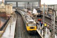 Steam engine and admirers at Carlisle. Getting no attention is a 47 hauled G&SW route train for Glasgow. While steam excursions still run to Carlisle by the S&C 47s hauling passenger trains no longer grace the G&SW.<br><br>[Ewan Crawford //1988]